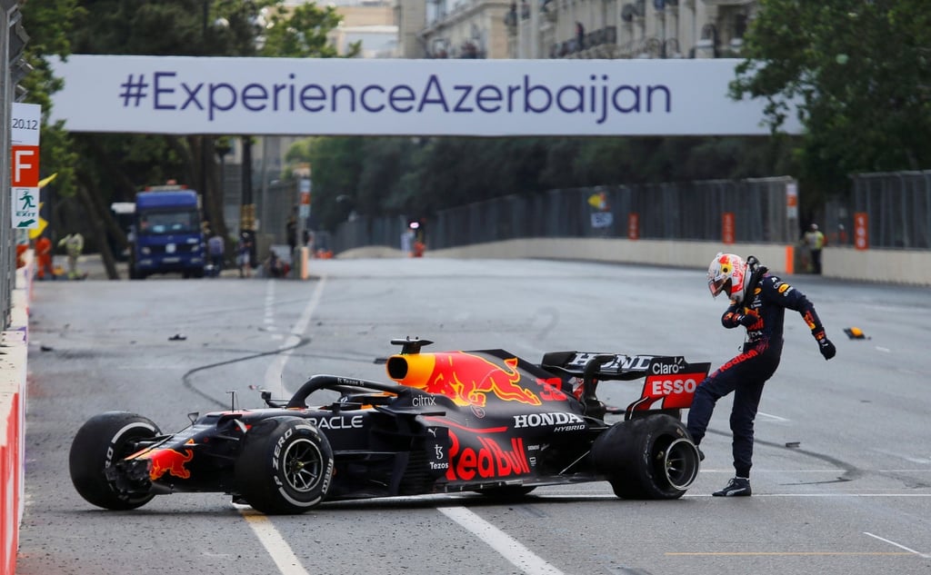 Max Verstappen kicks the wheel of his car after crashing out of the Azerbaijan Grand Prix. Photo: Reuters
