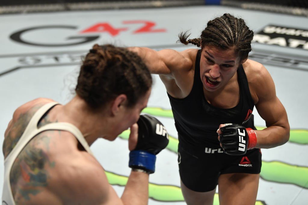 Julianna Pena (right) punches Sara McMann in a bantamweight fight at UFC 257. Photo: Jeff Bottari/Zuffa LLC