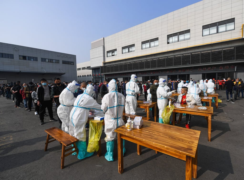 Medical workers take swab samples for Covid-19 testing at a market in Hangzhou on December 10. Photo: Xinhua