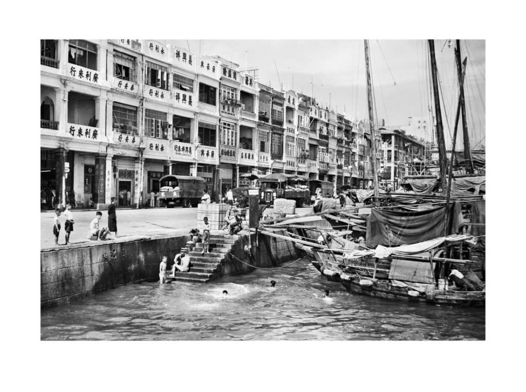 Rice is offloaded from sampans and junks, and local boys have some summer fun near Wing Lok Street. Photo: the estate of Lee Fook Chee Rice is offloaded from sampans and junks, and local boys have some summer fun near Wing Lok Street. Photo: the estate of Lee Fook Chee