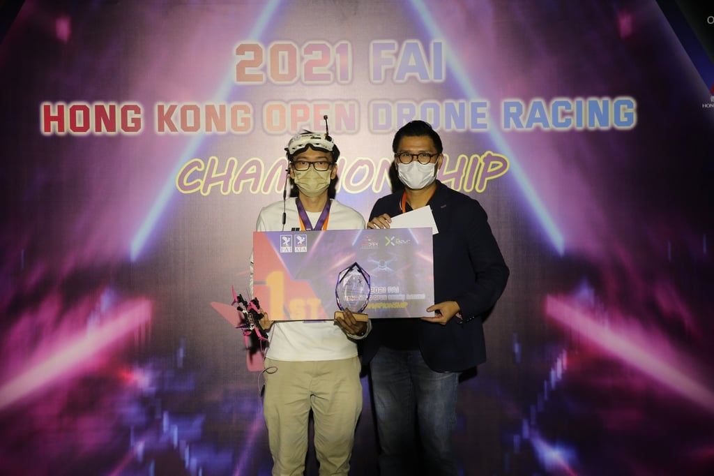 Hong Kong Open Drone Racing Championship winner Will Ho Wing-chi (left) with his award in Cyberport. Photo: Hong Kong Drone Sports Association
