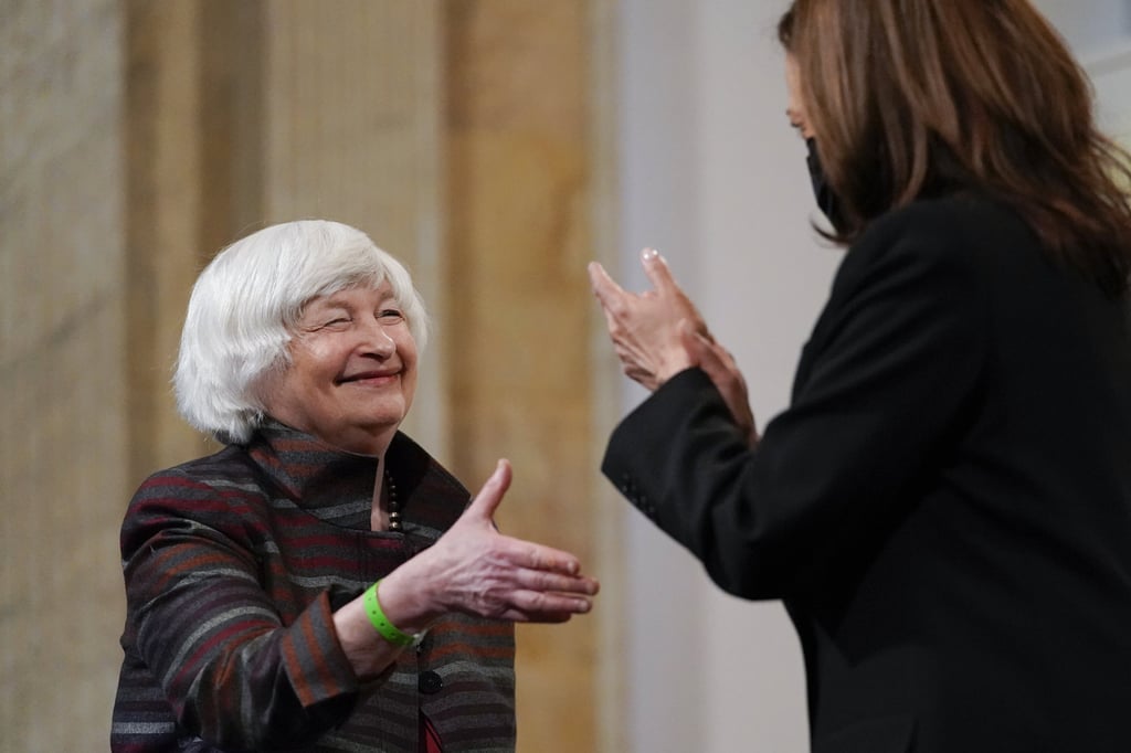 US Treasury Secretary Janet Yellen reaches to shake hands with Vice-President Kamala Harris as they take part in a forum at the Treasury Department in Washington on Tuesday. Photo: AP