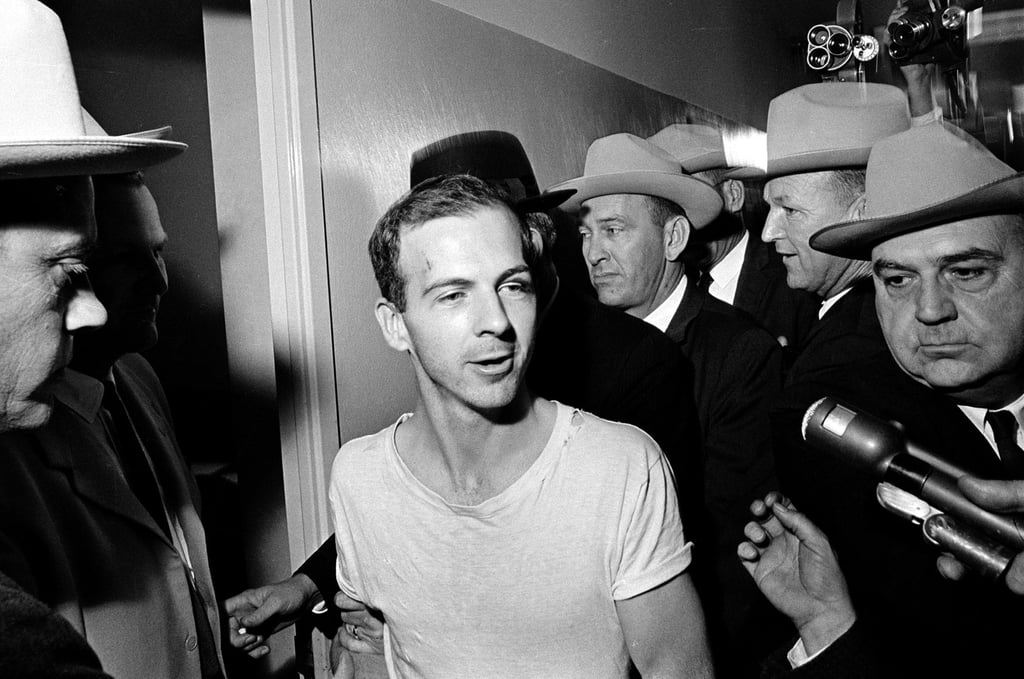 Surrounded by detectives, Lee Harvey Oswald talks to the media as he is led down a corridor of the Dallas police station for another round of questioning in connection with the assassination of US President John F. Kennedy in November 1963. Photo: AP