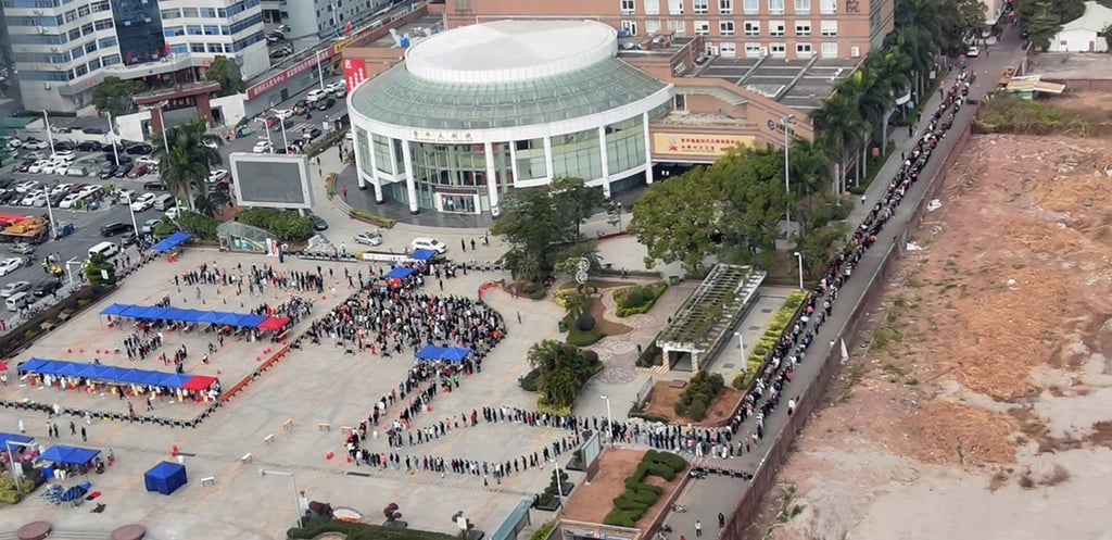 People in southern China’s Guangdong province line up for Covid-19 testing earlier this week. How the current breakout is handled could affect the final quota for cross-border travel, sources tell the Post. Photo: Weibo
