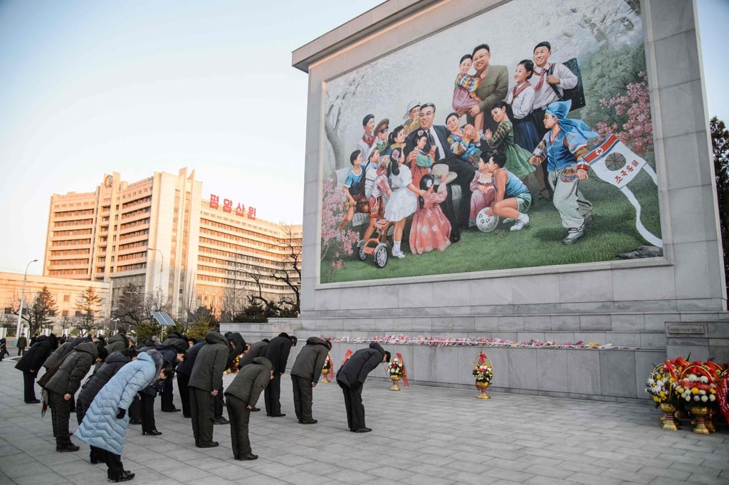 People in Pyongyang bow to pay their respects on December 17, 2021, in front of a mosaic showing a depiction of President Kim Il-sung and Kim Jong-il, as they mark the 10th anniversary of the death of Kim Jong-il, the father of current leader Kim Jong-un. Photo: AFP People in Pyongyang bow to pay their respects on December 17, 2021, in front of a mosaic showing a depiction of President Kim Il-sung and Kim Jong-il, as they mark the 10th anniversary of the death of Kim Jong-il, the father of current leader Kim Jong-un. Photo: AFP