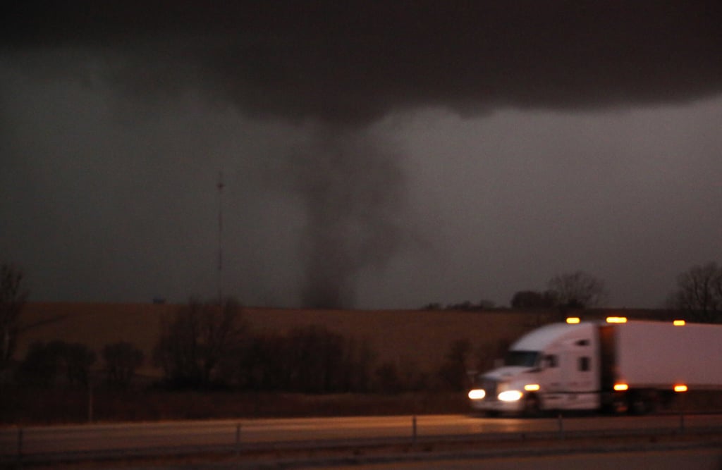 A tornado approaches Interstate 80 near Atlantic, Iowa, as a truck rolls eastward on Wednesday. Photo: The Des Moines Register via AP