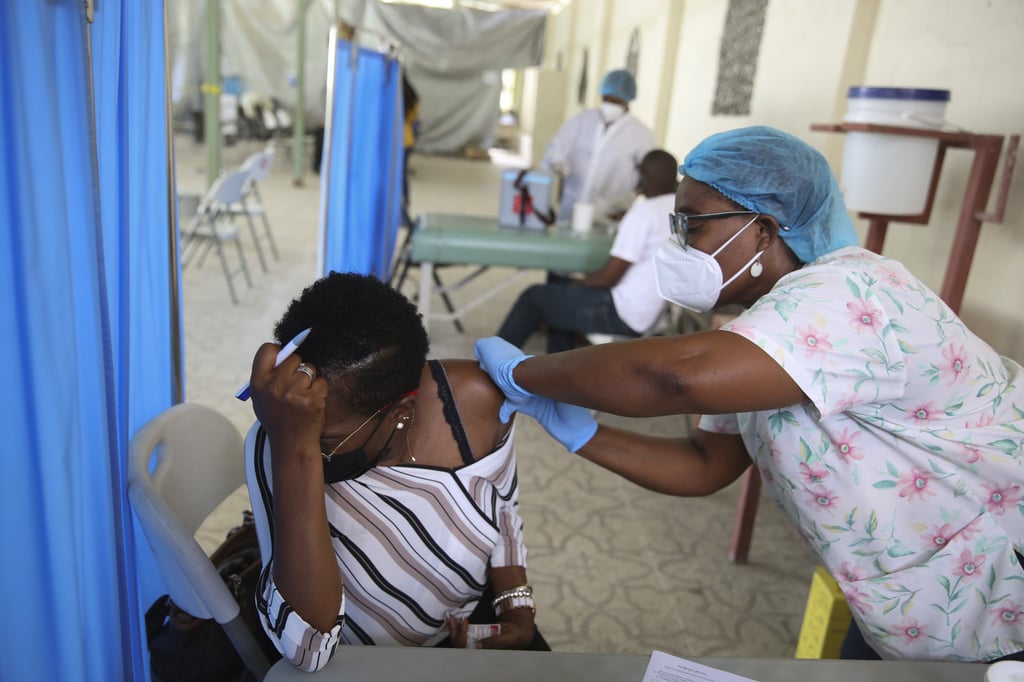 A health worker gives a patient a dose of the Moderna Covid-19 vaccine that was donated through the Covax initiative at Saint Damien Hospital in Port-au-Prince, Haiti in July. Photo: AP A health worker gives a patient a dose of the Moderna Covid-19 vaccine that was donated through the Covax initiative at Saint Damien Hospital in Port-au-Prince, Haiti in July. Photo: AP
