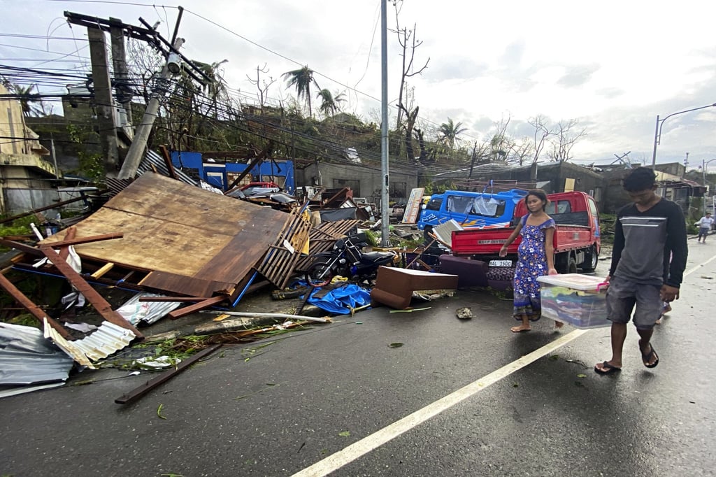 Residents carry what is left of their belongings in Surigao city, Surigao del Norte, central Philippines. Photo: AP