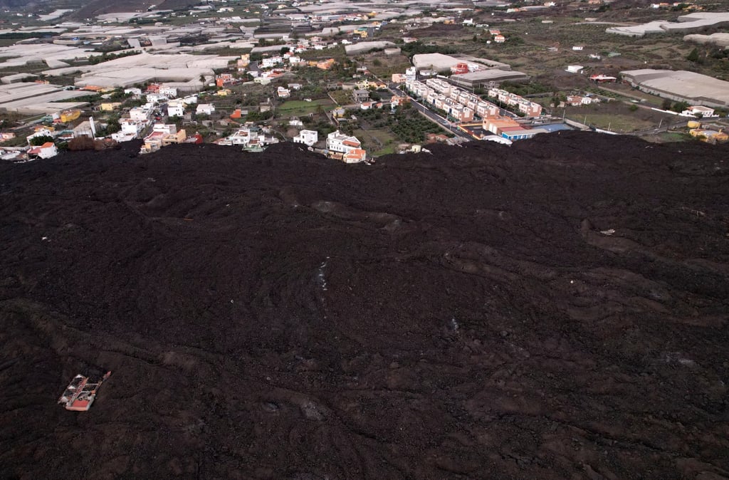 Aerial view of solidified lava from the Cumbre Vieja volcano, spilling over houses on the Canary Island of La Palma, Spain, on December 18. Drone photo: Reuters