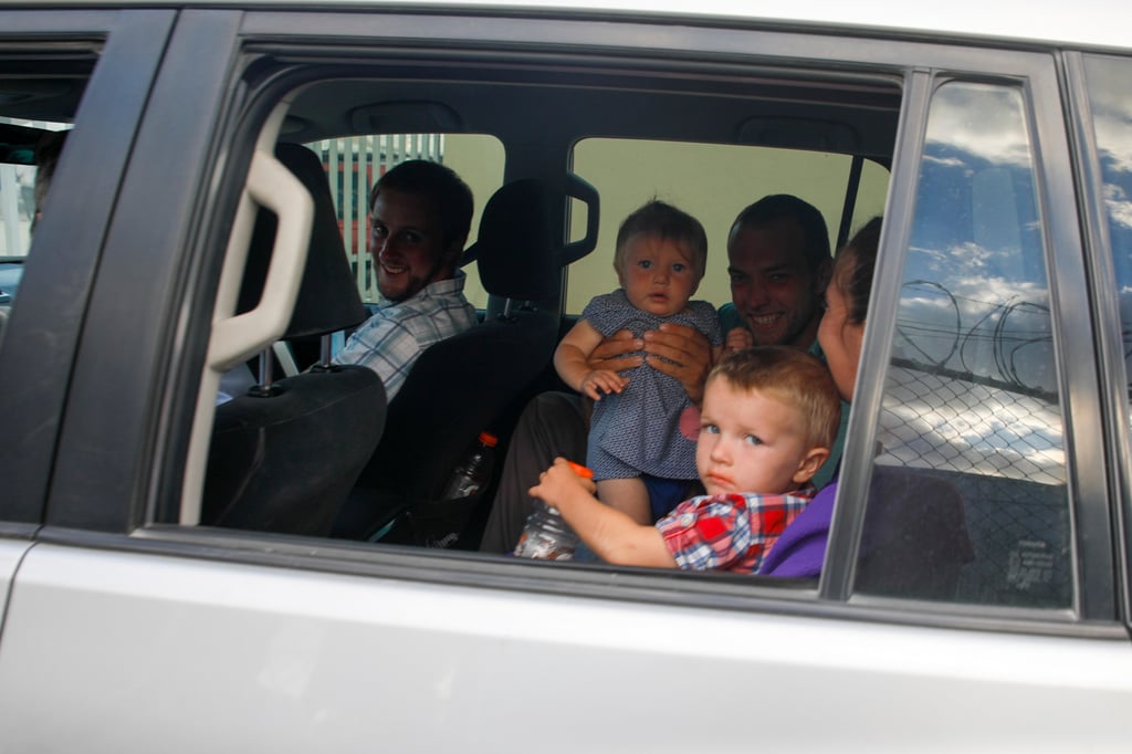 Unidentified people head to the airport from Christian Aid Ministries headquarters at Titanyen, north of Port-au-Prince, Haiti on December 16. Twelve remaining members of the US-based missionary group who were kidnapped two months ago have been freed. Photo: AP