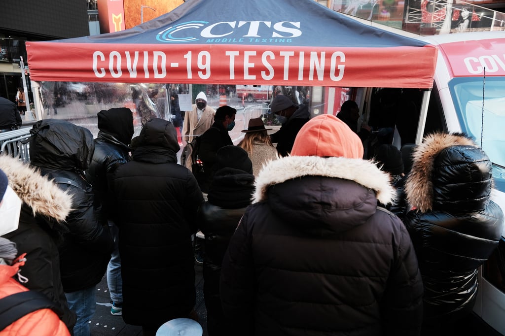 People wait in Times Square, New York, to get tested for Covid-19 on December 20. The city has once again seen case numbers surge as the new Omicron variant becomes dominant. Photo: Getty Images