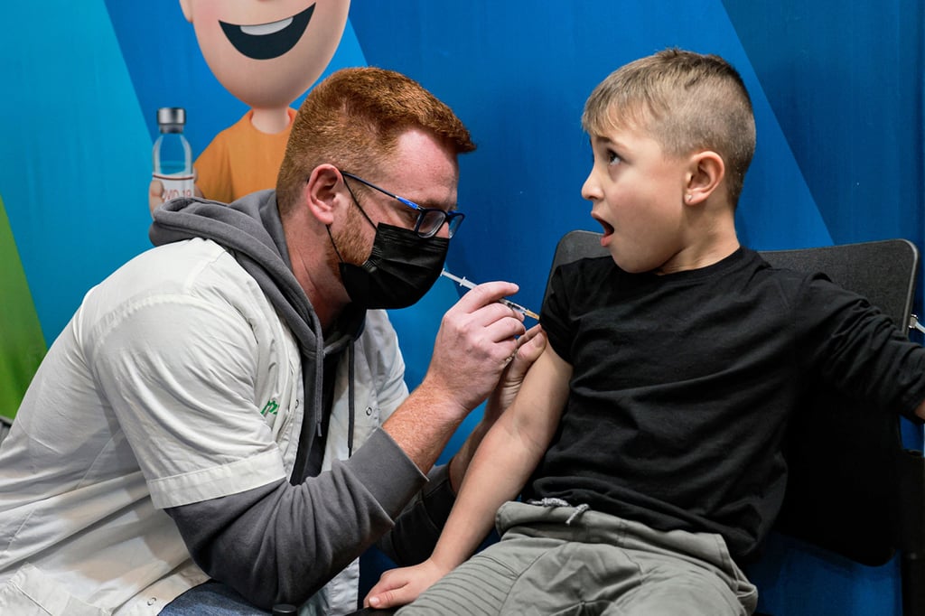 A boy being vaccinated in Israel in November 2021 as part of the roll out for children aged five to 11. A fourth shot Photo: AFP