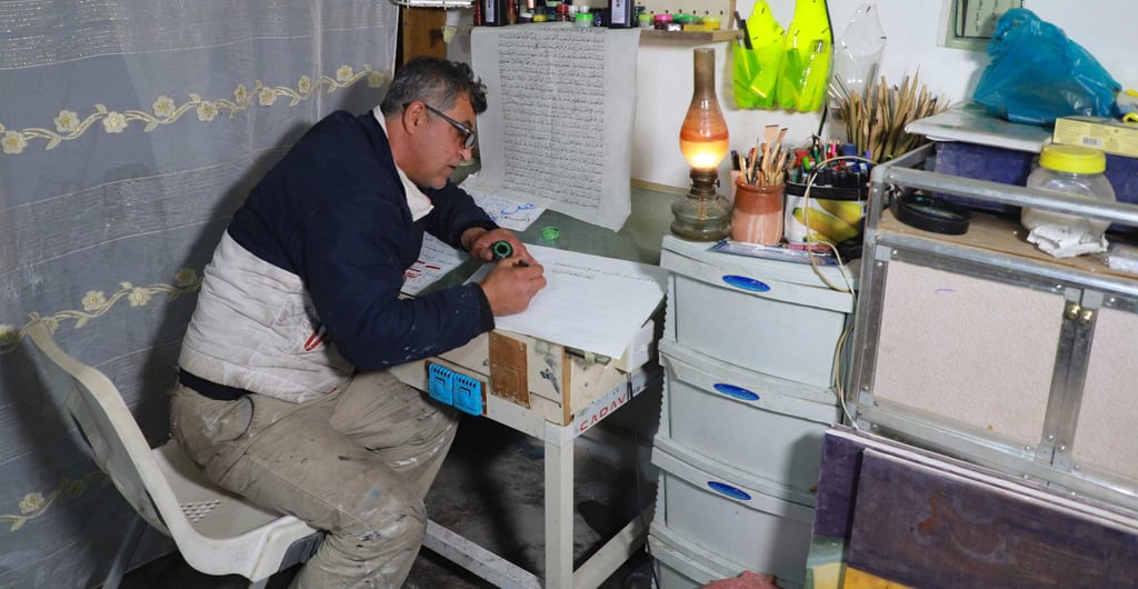 During his free time after working on construction sites in northern Iraq, Jamal Hussein indulges in his hobby of writing Arabic calligraphy at his home in Rania, in the autonomous Iraqi Kurdistan region. Photo: AFP During his free time after working on construction sites in northern Iraq, Jamal Hussein indulges in his hobby of writing Arabic calligraphy at his home in Rania, in the autonomous Iraqi Kurdistan region. Photo: AFP
