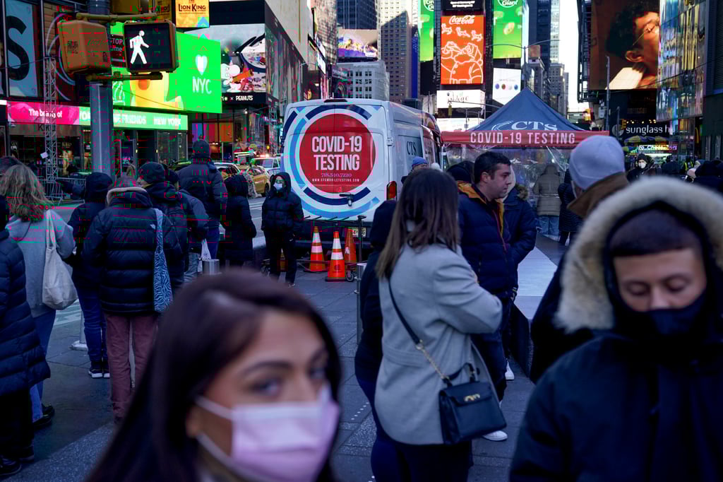 People wait in a long line to get tested for Covid-19 in Times Square, New York, on Monday. Photo: AP People wait in a long line to get tested for Covid-19 in Times Square, New York, on Monday. Photo: AP