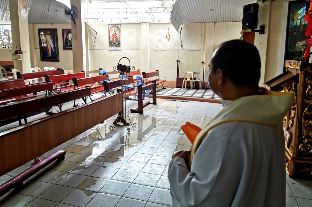 Father Ricardo Virtudzo standing inside his typhoon-hit church in Alegria, Surigao del Norte province. Photo: AFP Father Ricardo Virtudzo standing inside his typhoon-hit church in Alegria, Surigao del Norte province. Photo: AFP