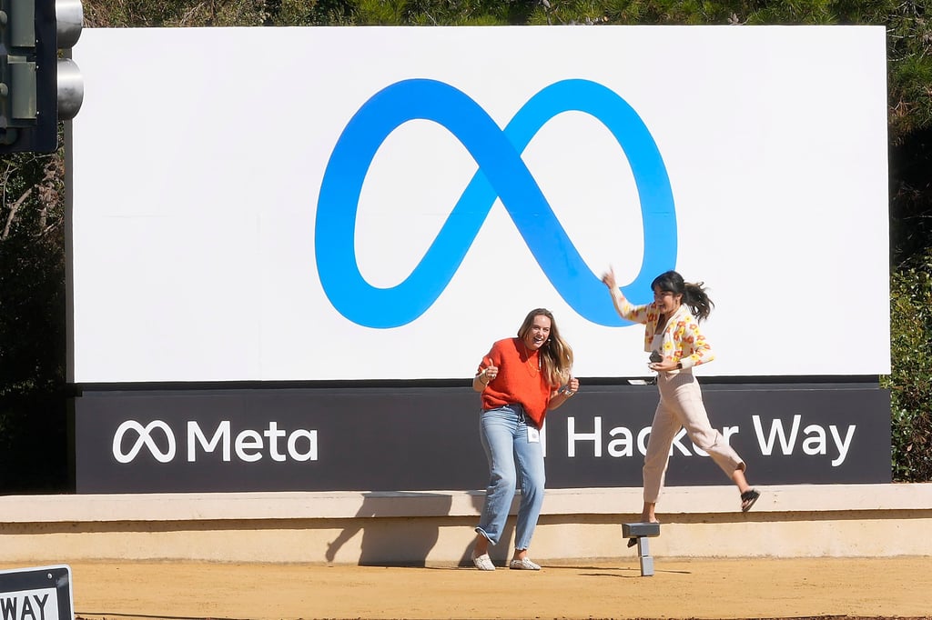 Facebook employees take a photo with the company’s new name and logo outside its headquarters in Menlo Park, California, in October. Photo: AP