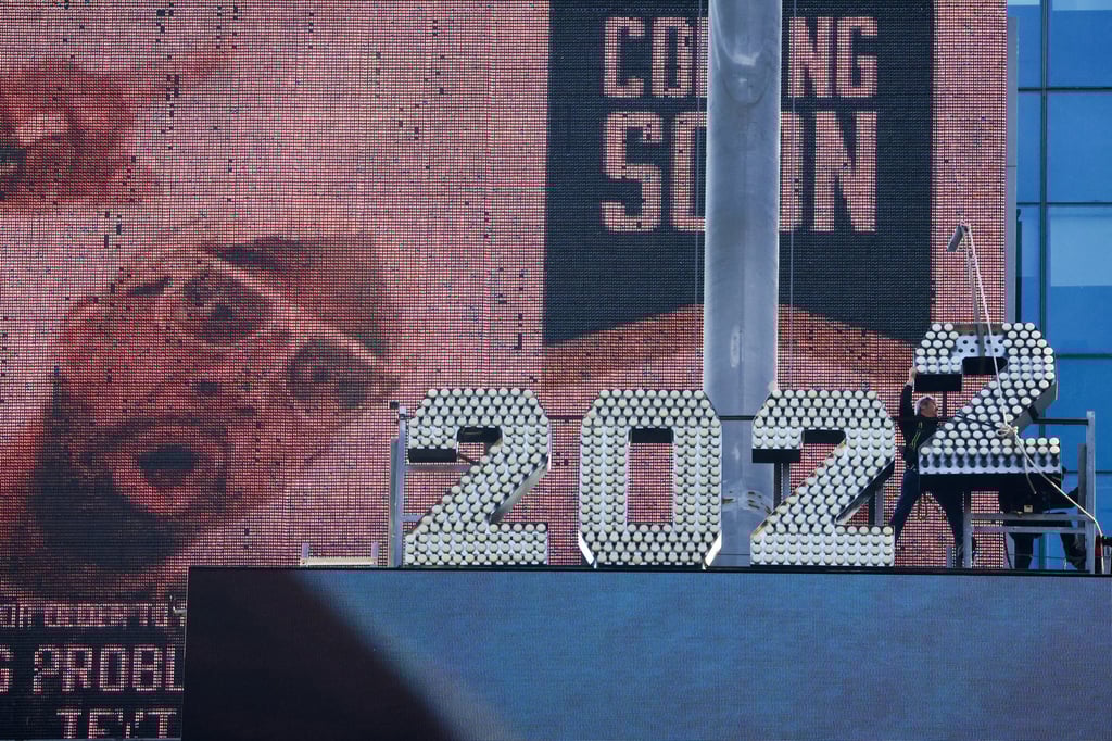 Workers add the number 2 to the numerals above Times Square on Sunday ahead of New Year’s Eve celebrations in New York. Photo: Reuters Workers add the number 2 to the numerals above Times Square on Sunday ahead of New Year’s Eve celebrations in New York. Photo: Reuters
