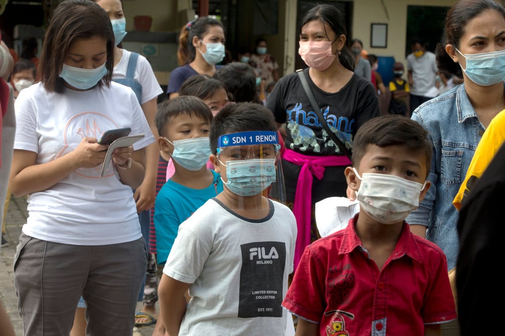 Children queue to receive a dose of Sinovac Covid-19 vaccine at a school in Bali, Indonesia, on Thursday. Photo: AP