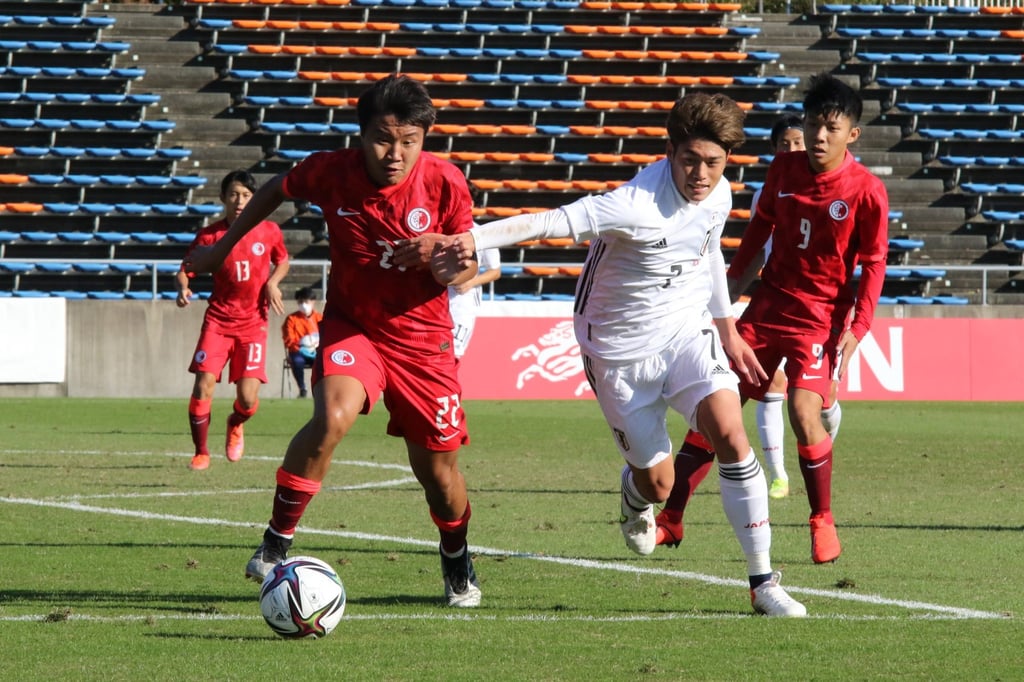 Lam Hin-ting (left) against Japan in their AFC U23 Championship qualifier. Photo: HKFA