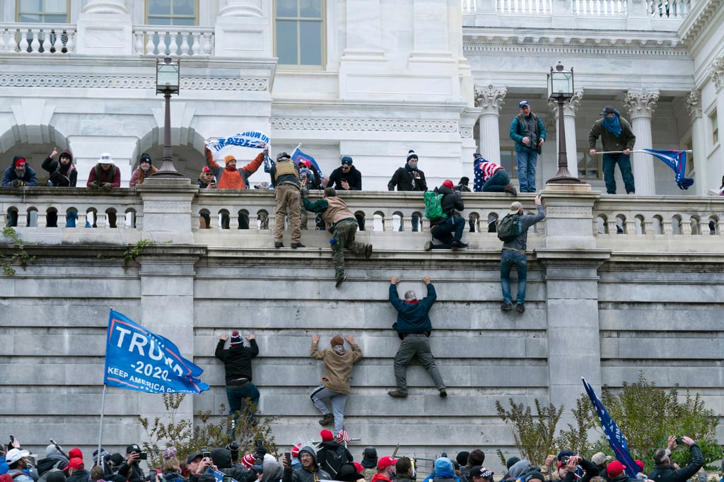 Insurrectionists loyal to former US president Donald Trump climb the west wall of the US Capitol in Washington on January 6. Photo: AP