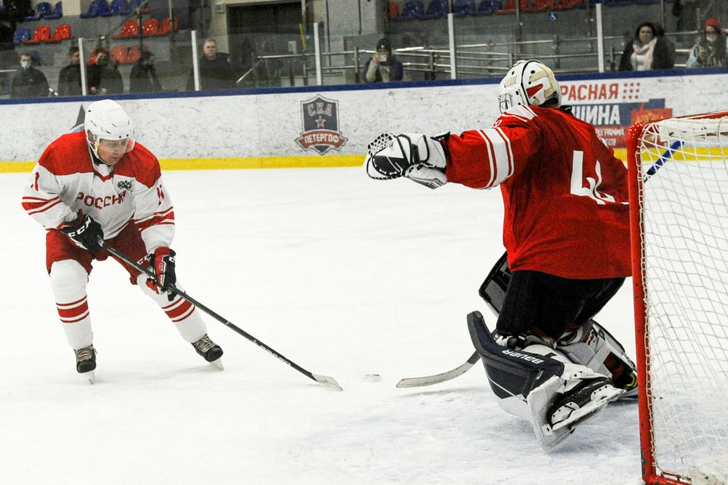 Russian President Vladimir Putin (left) tries to score during the Night Hockey League match on the sidelines of his meeting with Belarusian President Alexander Lukashenko in Strelna, outside St Petersburg, on Wednesday. Photo: Sputnik via AP Russian President Vladimir Putin (left) tries to score during the Night Hockey League match on the sidelines of his meeting with Belarusian President Alexander Lukashenko in Strelna, outside St Petersburg, on Wednesday. Photo: Sputnik via AP