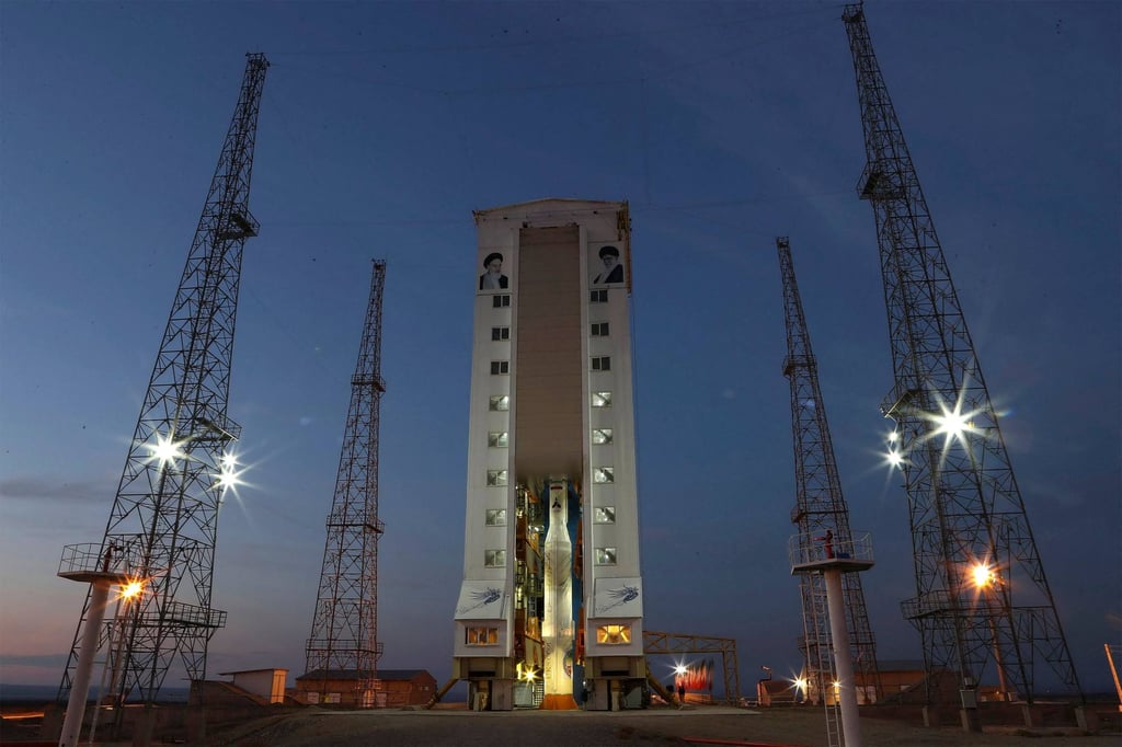 A Simorgh (Phoenix) satellite rocket is seen on a launch pad beneath the portraits of Iran’s Supreme leader Ayatollah Ali Khamenei (right) and the late founder of the Islamic republic Ayatollah Ruhollah Khomeini (left) at an undisclosed location in Iran. Photo: Iranian defence ministry via AFP