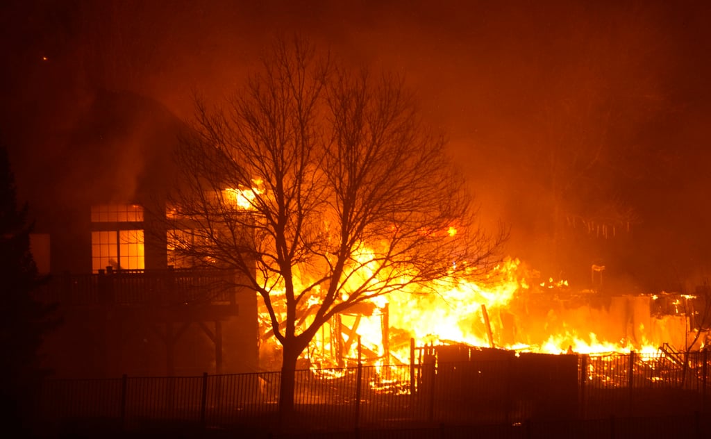 Homes burn as wildfires rip through a development in Superior, Colorado. Photo: AP Homes burn as wildfires rip through a development in Superior, Colorado. Photo: AP