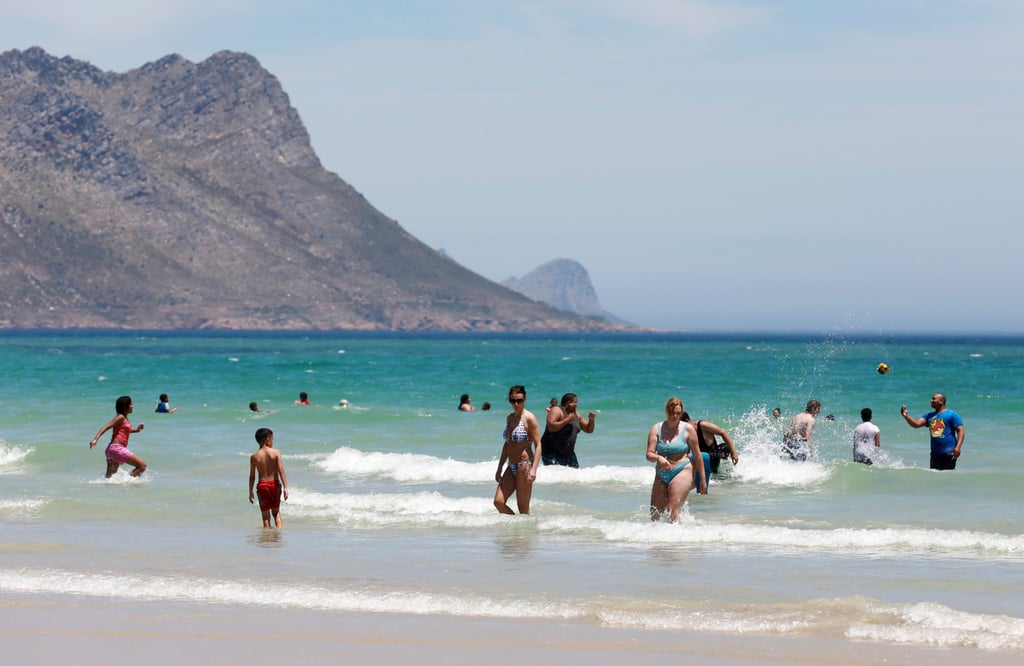 People at Strand Beach near Cape Town, South Africa. Photo: AP People at Strand Beach near Cape Town, South Africa. Photo: AP