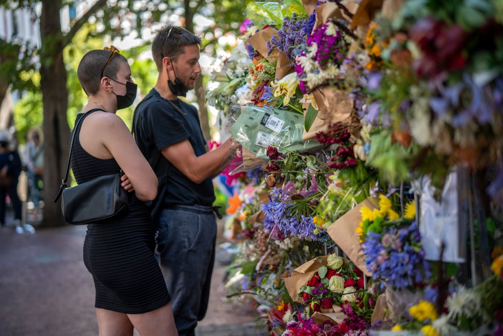 People read cards left with flowers in memory of Archbishop Desmond Tutu at St George’s Cathedral in Cape Town, South Africa. Photo: AP