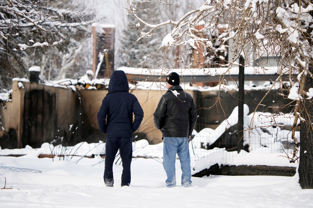 Men survey the remains of a home destroyed by fire in Superior, Colorado on January 1. Photo: AP
