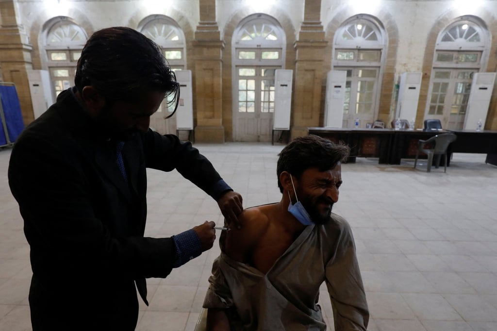 A man receives a vaccine in Karachi, Pakistan. Photo: Reuters