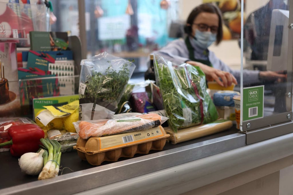 A cashier scans goods at a Waitrose supermarket in London on December 29. Inflation in Britain has rocketed to its highest level for more than 10 years on broad-based price gains, data showed last month. Surging inflation risks could torpedo global growth this year. Photo: AFP A cashier scans goods at a Waitrose supermarket in London on December 29. Inflation in Britain has rocketed to its highest level for more than 10 years on broad-based price gains, data showed last month. Surging inflation risks could torpedo global growth this year. Photo: AFP