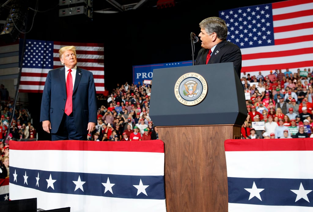 Then US President Donald Trump (left) listens Fox News’ Sean Hannity speak during a rally in Missouri in November 2018. Photo: AP