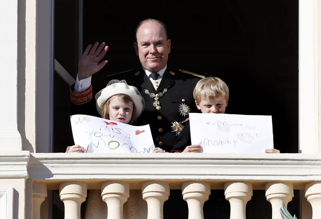 Monaco’s Prince Albert II waves as his children, Prince Jacques and Princess Gabriella, hold messages for their mother Princess Charlene during celebrations marking Monaco’s National Day, in November 2021. Photo: EPA-EFE