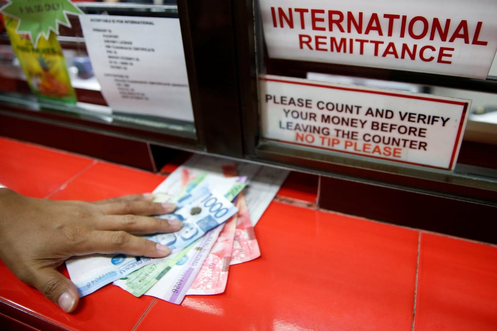 Philippine peso bills sent by a Filipino working abroad are received by a relative at a money remittance centre in Makati City, Metro Manila, in the Philippines, on September 19, 2018. Photo: Reuters Philippine peso bills sent by a Filipino working abroad are received by a relative at a money remittance centre in Makati City, Metro Manila, in the Philippines, on September 19, 2018. Photo: Reuters