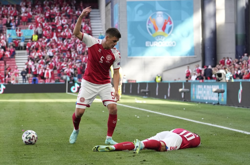 Denmark’s Joakim Maehle reacts as Christian Eriksen lies on the pitch after collapsing witih a cardiac arrest. Photo: AP/Martin Meissner Denmark’s Joakim Maehle reacts as Christian Eriksen lies on the pitch after collapsing witih a cardiac arrest. Photo: AP/Martin Meissner