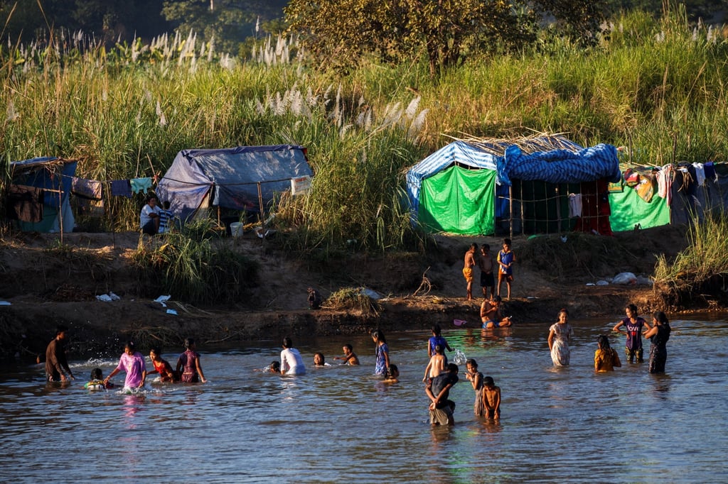 Myanmar refugees bathe in the river waters on the Thai-Myanmar border. Photo: Reuters