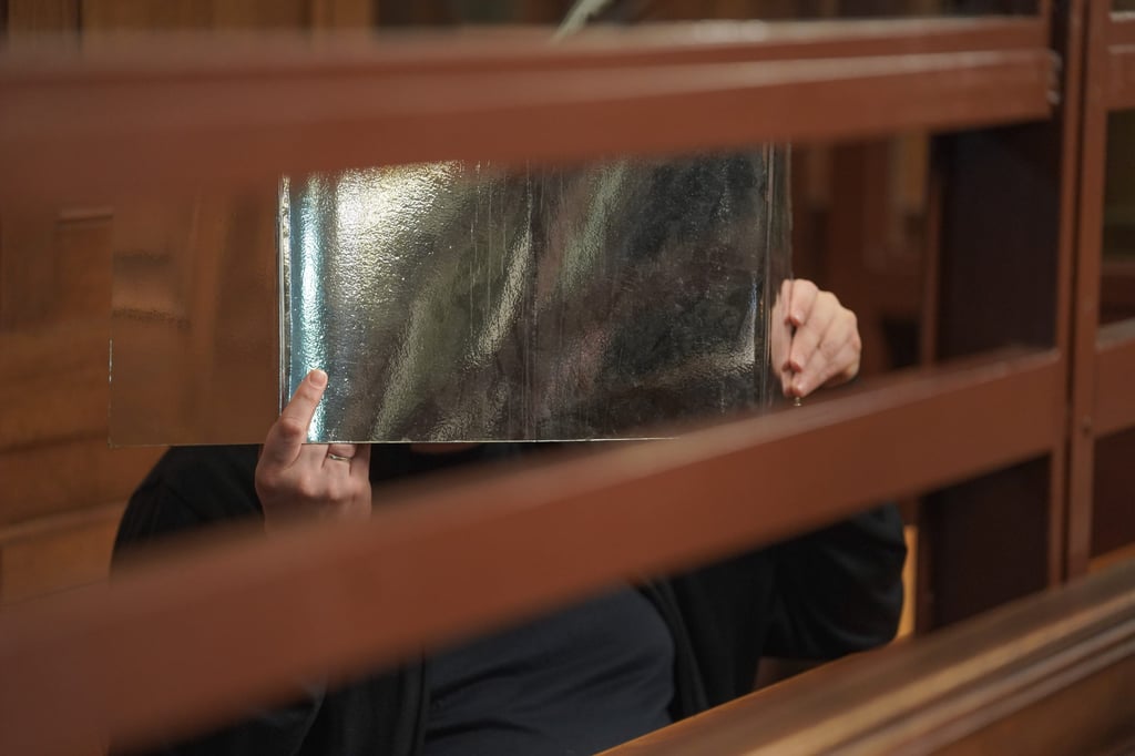 A 42-year-old German teacher covers his face during the “cannibalism trial” in Berlin on Friday. Photo: dpa