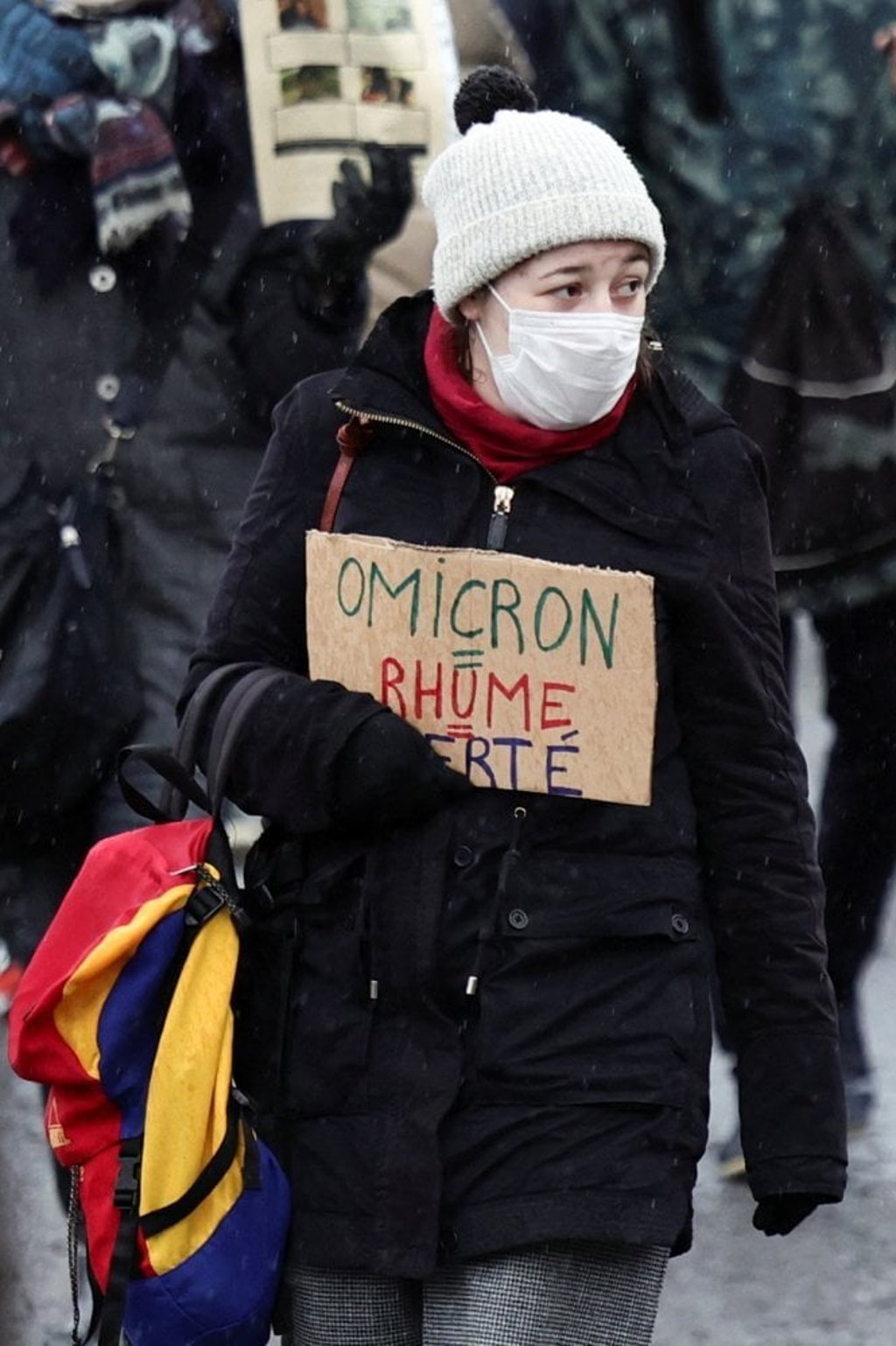 A person holds a sign that reads ‘Omicron = Flu’ at a protest against coronavirus measures in Paris, France on Saturday. Photo: Reuters