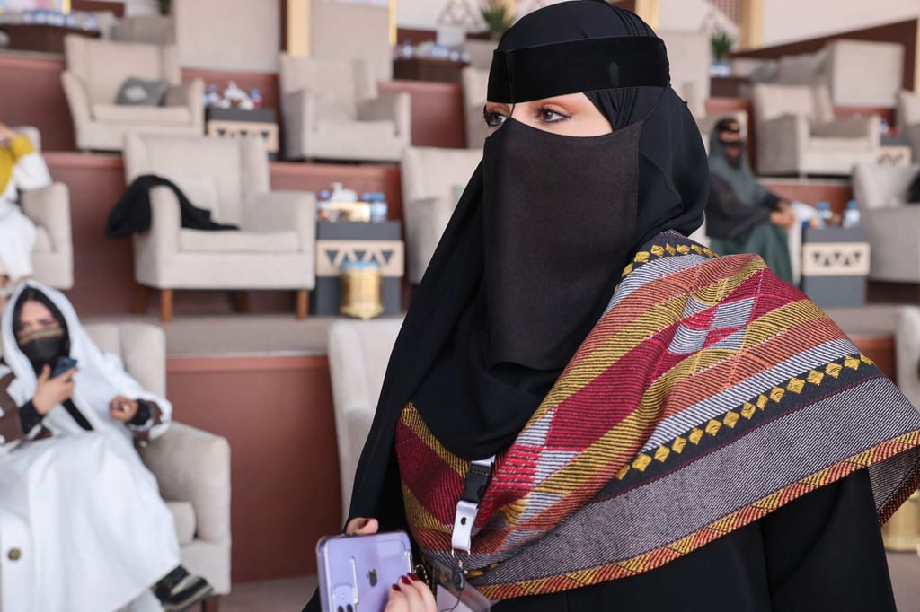 Saudi camel owner Lamiaa al-Rashidi, 27, talks to reporters about her participation in the King Abdulaziz Camel Festival. Photo: AFP