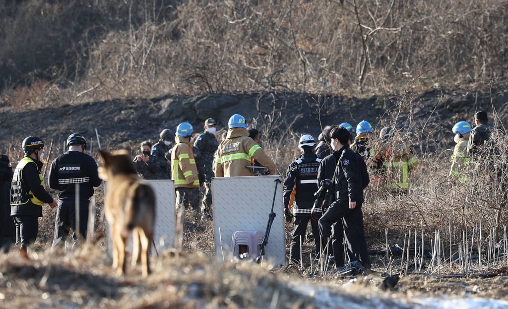 Military officials check the wreckage of a F-5E jet on a hill in Hwaseong. Photo: EPA-EFE/Yonhap