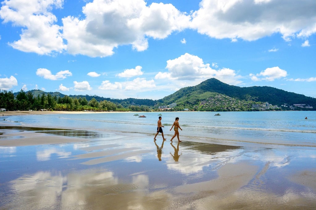Visitors walk on a beach on the Thai island of Phuket on November 1. The World Travel and Tourism Council estimates that 62 million travel and tourism related jobs were lost worldwide in 2020. Photo: AFP