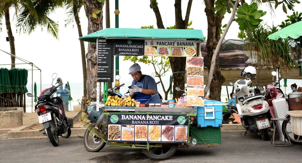 A banana pancake vendor in Phuket, which is part of the “Sandbox” scheme where fully vaccinated travellers spend seven nights in the sandbox area then can move elsewhere in Thailand. Photo: AFP A banana pancake vendor in Phuket, which is part of the “Sandbox” scheme where fully vaccinated travellers spend seven nights in the sandbox area then can move elsewhere in Thailand. Photo: AFP