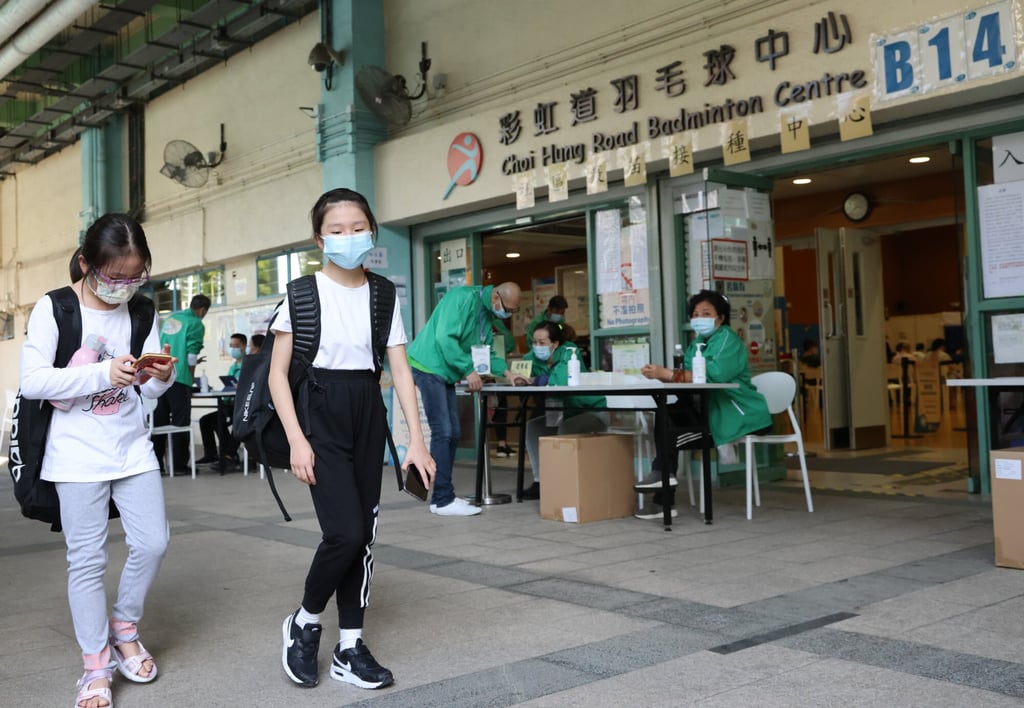 Children pass a Covid-19 vaccination clinic at Choi Hung Road Badminton Centre in Hong Kong. Photo: May Tse