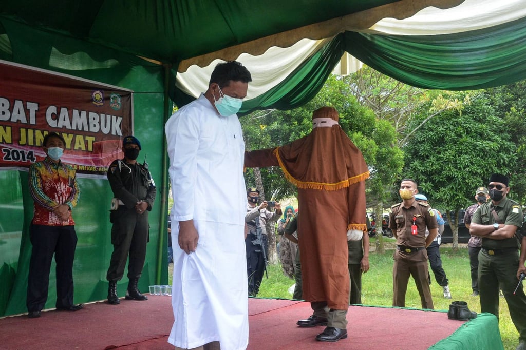 A man, who denied accusations of adultery, is flogged 15 times in Idi, East Aceh. Photo: AFP