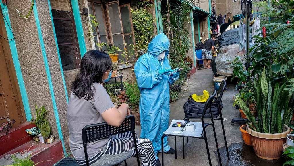 A health worker conducts an at-home Covid-19 antigen test in Quezon City. Photo: Xinhua