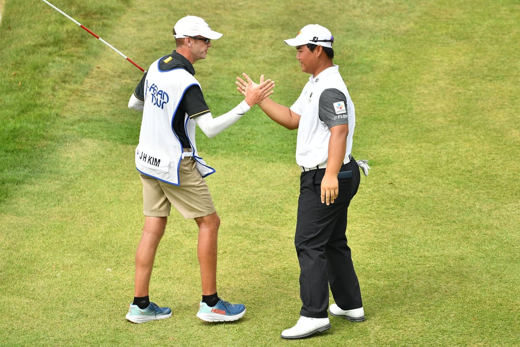 Joohyung Kim and caddie Jacob Flack celebrate winning The Singapore International. Photo: Asian Tour.