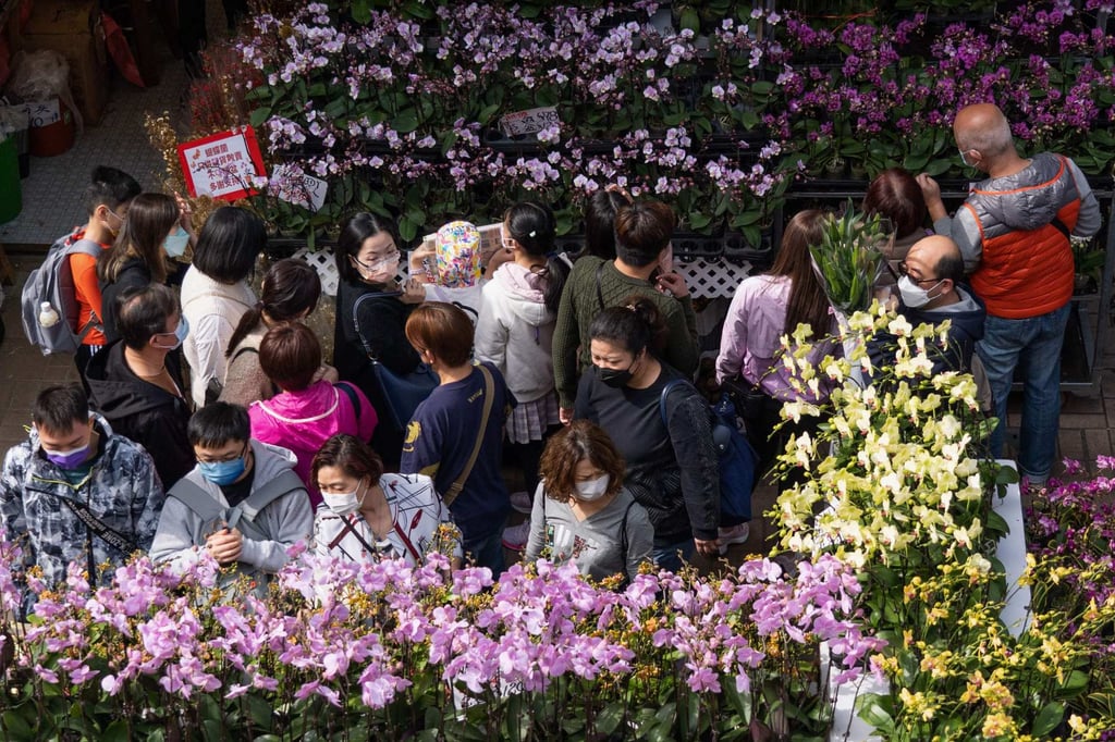 People walk through a flower market in Hong Kong’s Prince Edward area on January 16. According to census data, Hong Kong’s consumer price index rose by an annualised 1.8 per cent in November. Photo: AFP