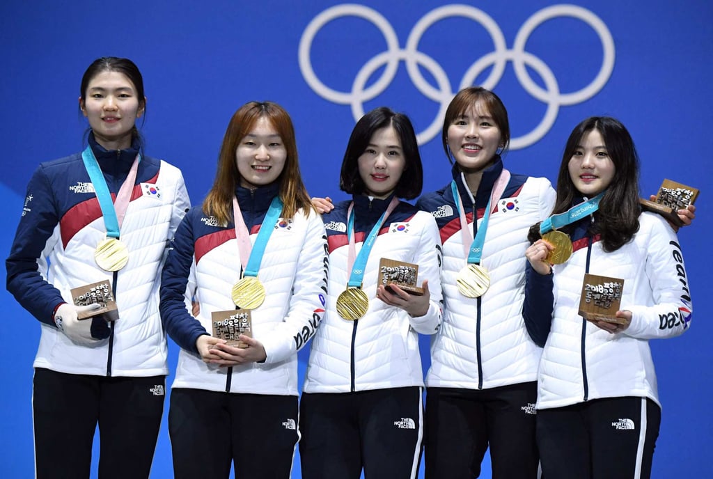 South Korea’s gold medallists Shim Suk-hee (left) and teammates Choi Min-jeong, Kim Ye-jin, Kim A-lang and Lee Yu-bin posing on the podium after winning the short track women’s 3000m relay at the Pyeongchang 2018 Winter Olympic Games. Photo: AFP