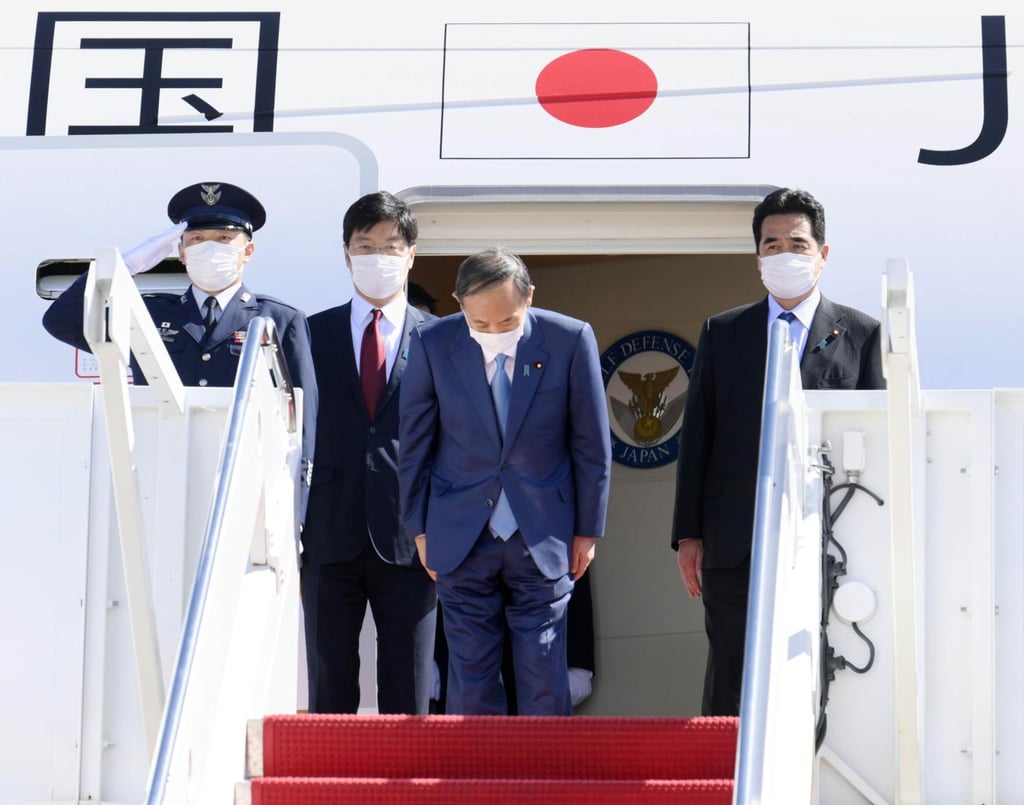 Then Japanese Prime Minister Yoshihide Suga bows before leaving the US in September. During his trip he took part in a “Quad” summit meeting with leaders of the United States, Australia and India. Photo: Kyodo